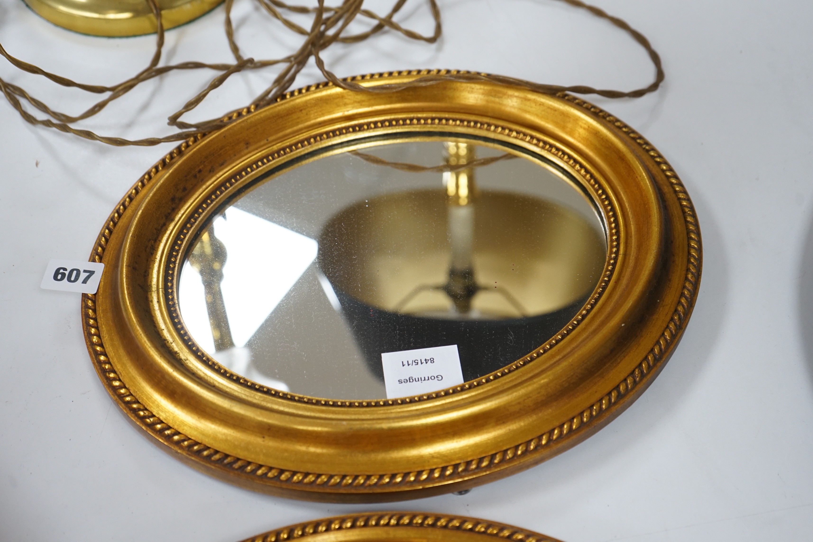 A small pair of oval gilt plaster framed wall mirrors, 34x30cm